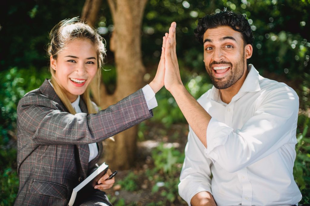 Happy Man and Woman high five each other for Confidence in God